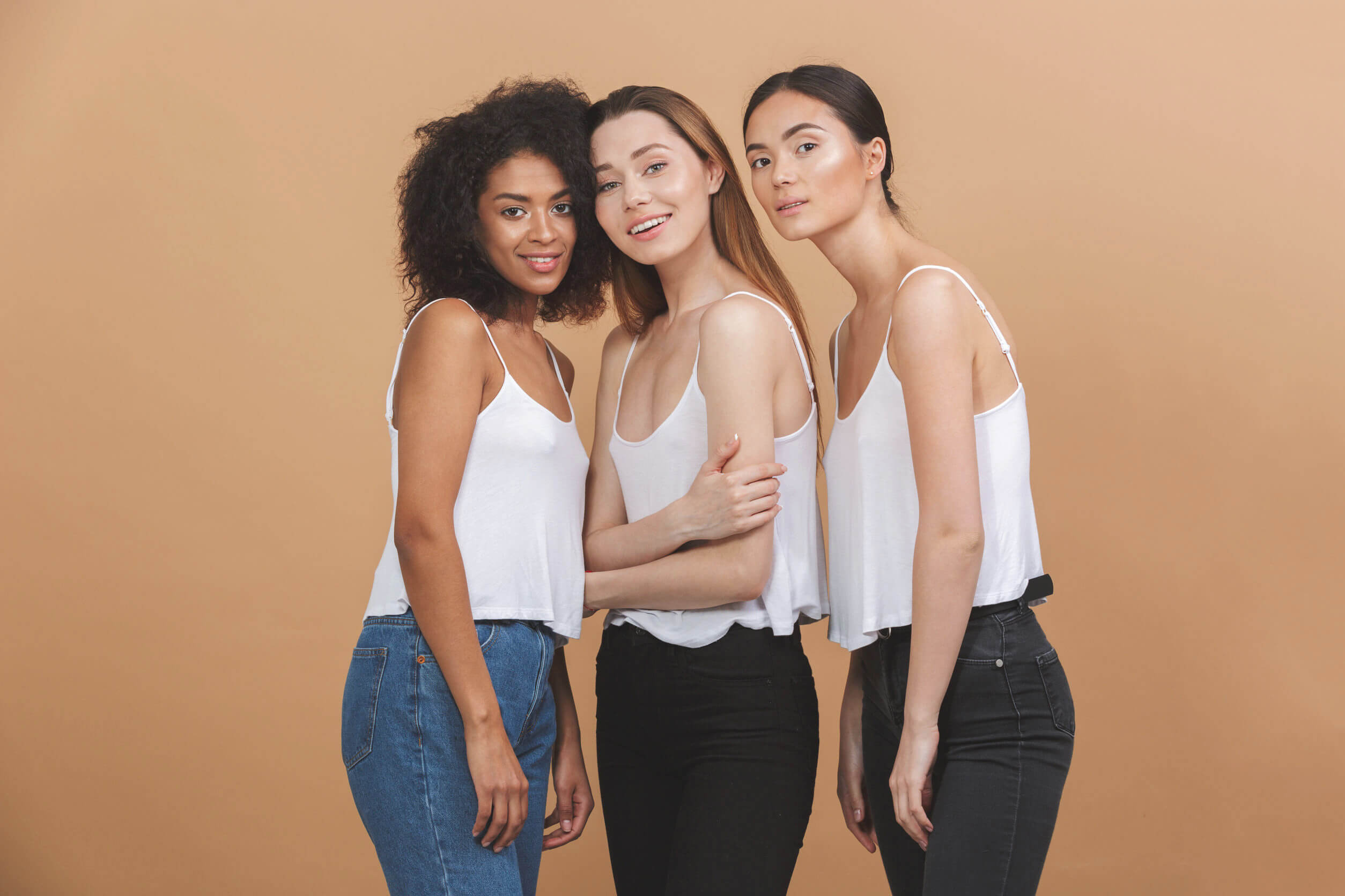 three women in jeans and white tank tops
